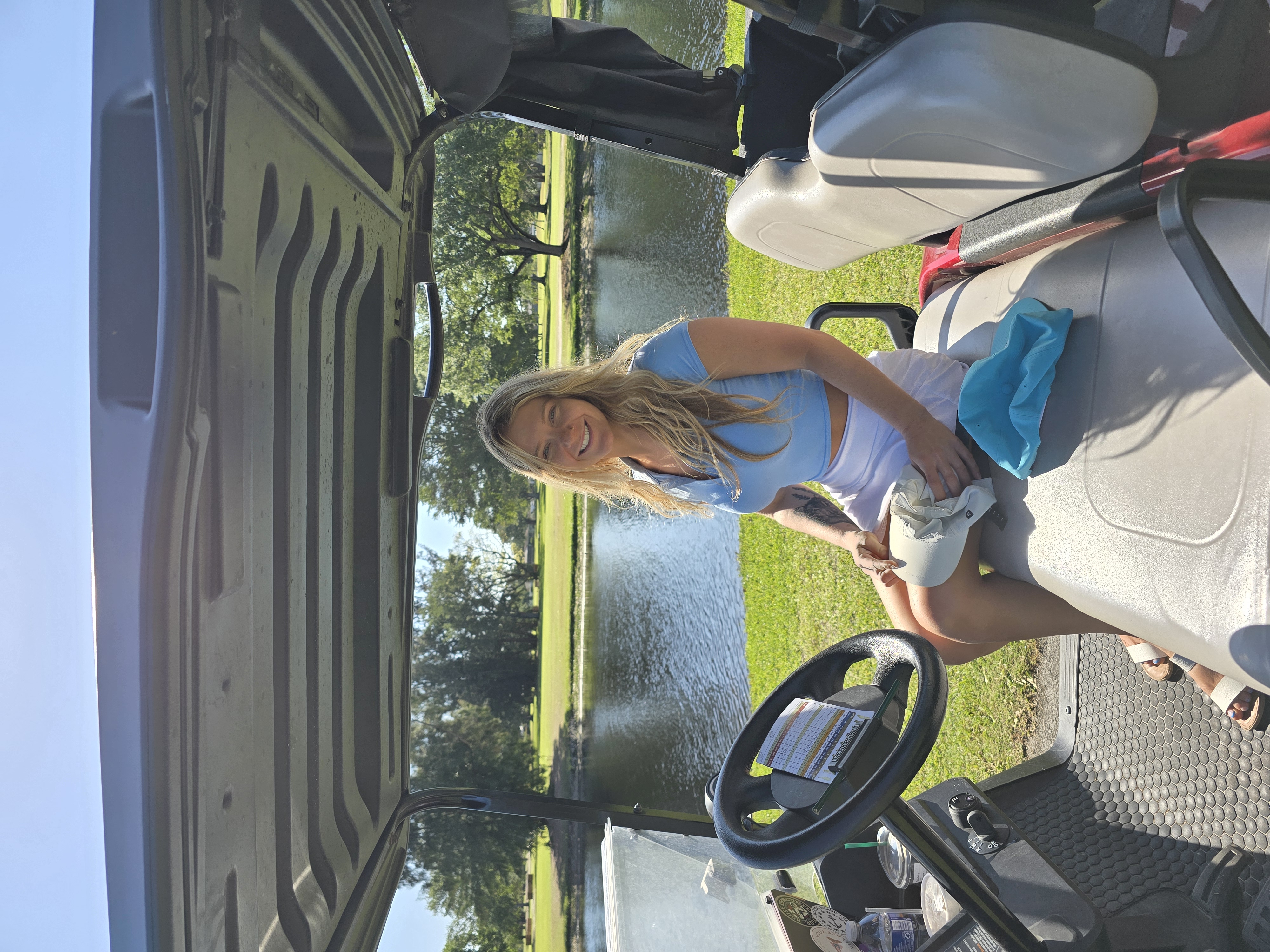 Danielle riding in a golf cart