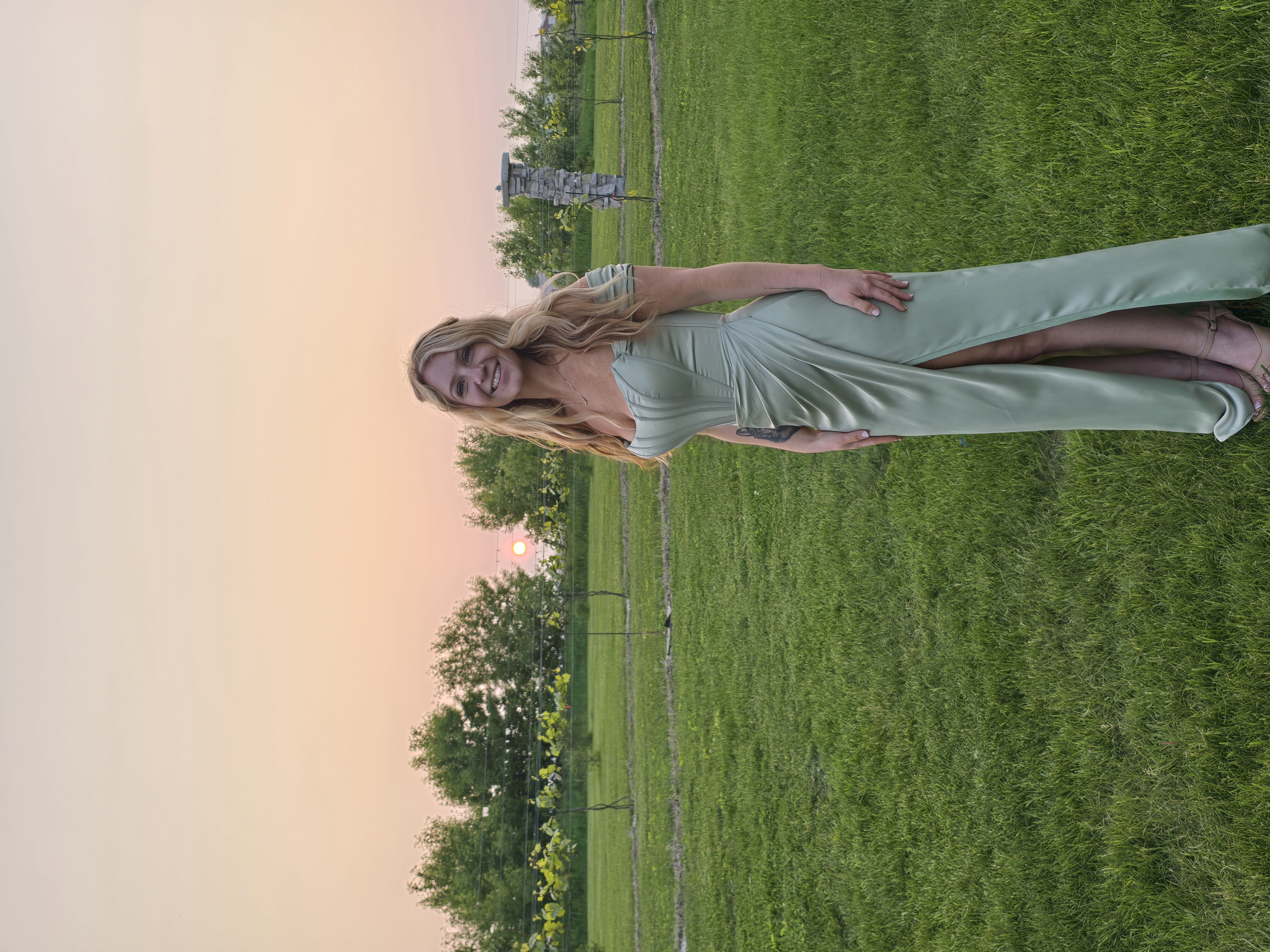 Danielle in a green dress at sunset